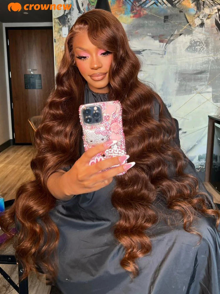 Person with long wavy hair taking a mirror selfie, wearing a sparkly phone case.